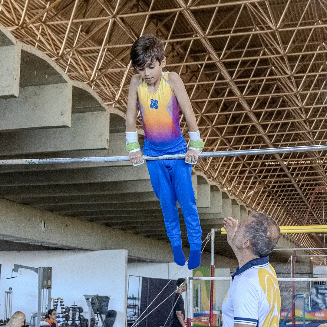 Ginasta na barra fixa durante a série masculina