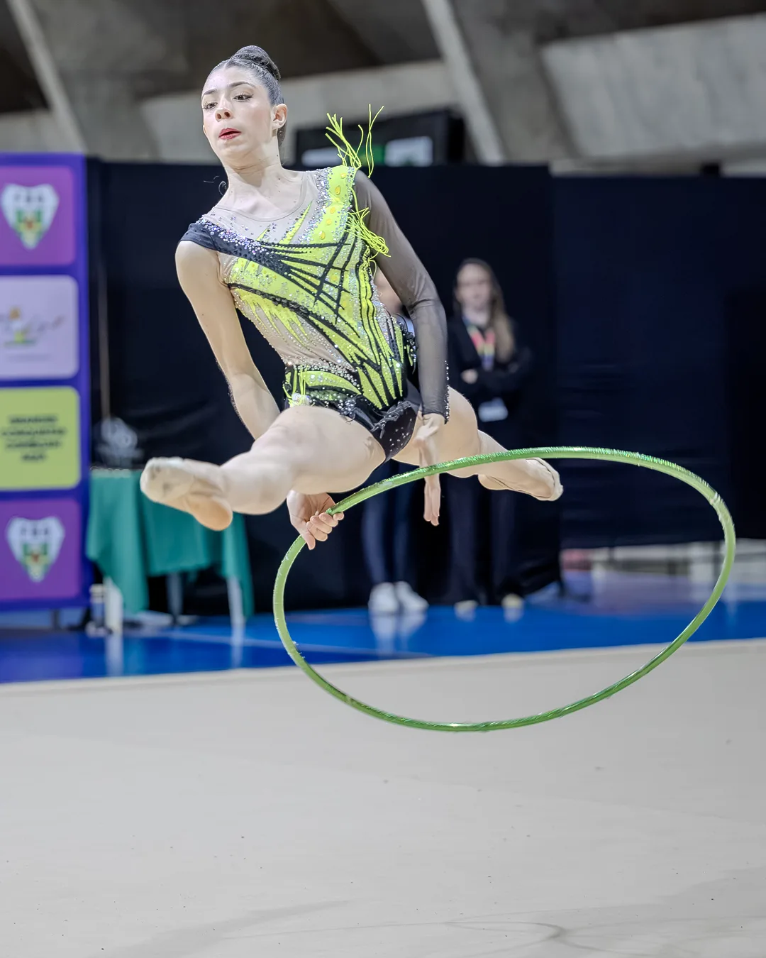 Ginasta atravessando o arco em pleno salto